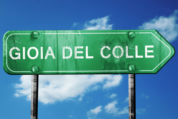 Gioia del colle road sign, vintage green with clouds background - Foto, imagen