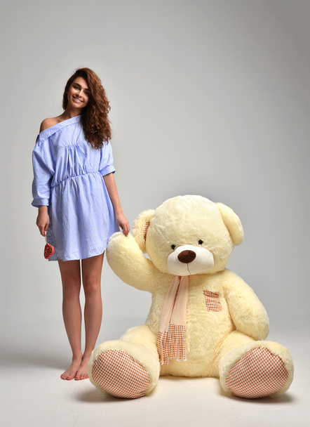 Young beautiful girl with big teddy bear soft toy happy smiling  - Fotografie, Obrázek