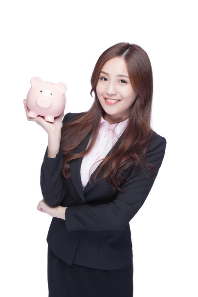businesswoman holding pink piggy - Fotoğraf, Görsel