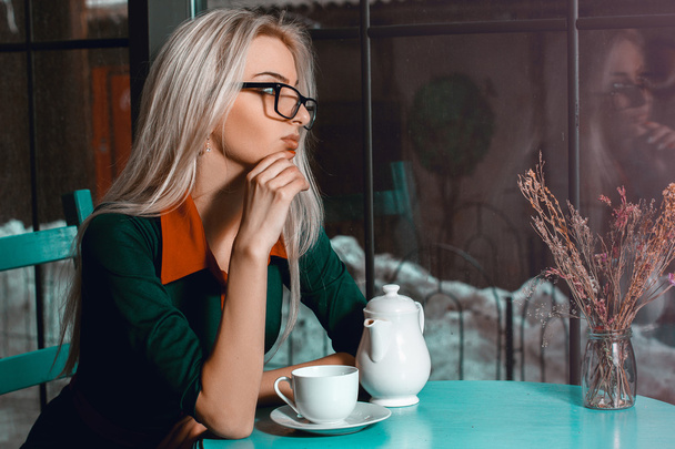 Beautiful blonde business woman in cafe thinking about something - 写真・画像