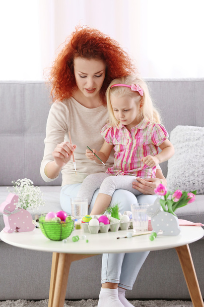 Mother and daughter decorating Easter eggs - Photo, image