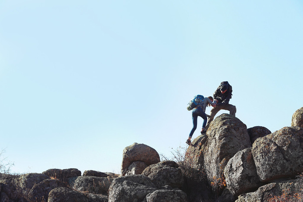 Man and woman climbing the mountain - Фото, зображення