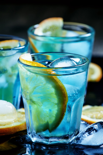 Blue cocktail with blue curacao liqueur and orange  - Photo, image