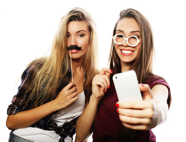 Two teenage girls friends in hipster outfit make selfie - 写真・画像