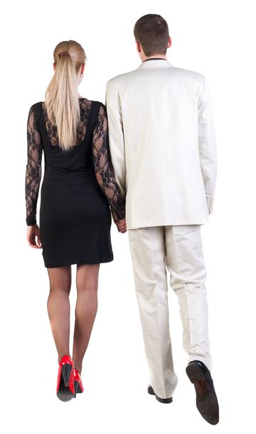 Back view of going young business couple (man and woman) . - Foto, Imagem