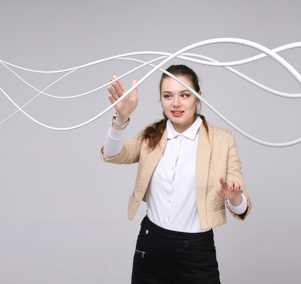 Woman with electrical cables or wires, curved lines - Fotoğraf, Görsel