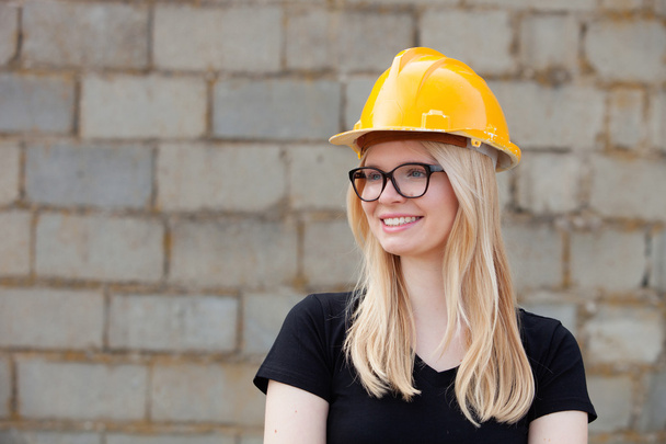 Young architect woman with yellow helmet  - Photo, Image