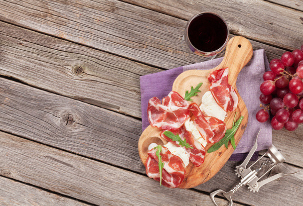 Prosciutto and mozzarella with red wine - Photo, image
