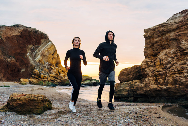 fitness couple running on beach - 写真・画像