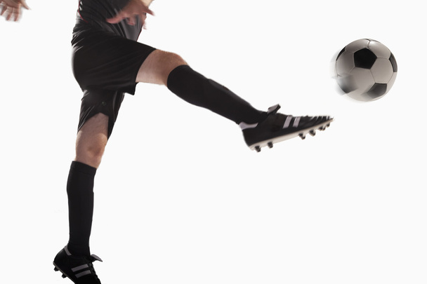 Atleta pateando pelota de fútbol
 - Foto, Imagen