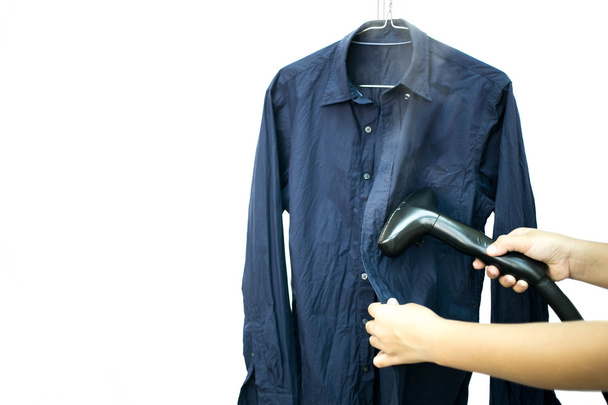 Woman ironing a blue shirt with steam iron isolated - Photo, Image