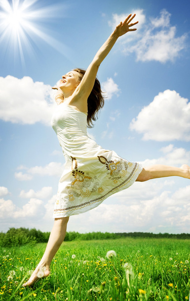 Happy Young Woman Jumping Over Blue Sky - Фото, зображення