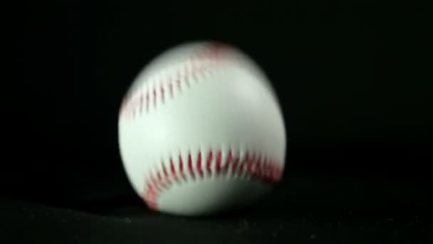 Baseballový míč na černém pozadí, zpomalené - Záběry, video