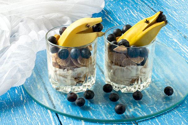 Creative breakfast with cereal flakes, yogurt, blueberries and b - Photo, Image