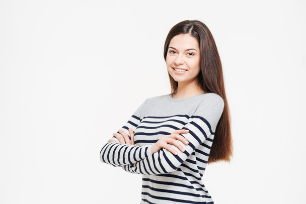 Smiling woman with arms folded looking at camera - Foto, Bild