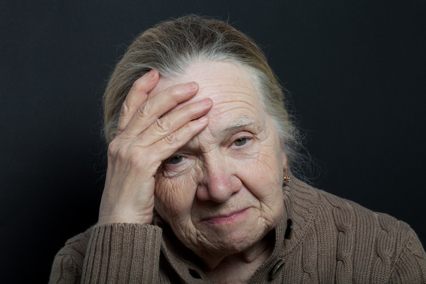 Portrait of elderly woman on dark background - Фото, зображення