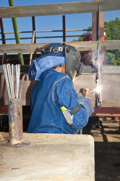 Woman welding wearing protective clothes and equipment - Photo, Image