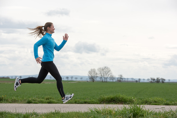 woman jogging outdoors - 写真・画像