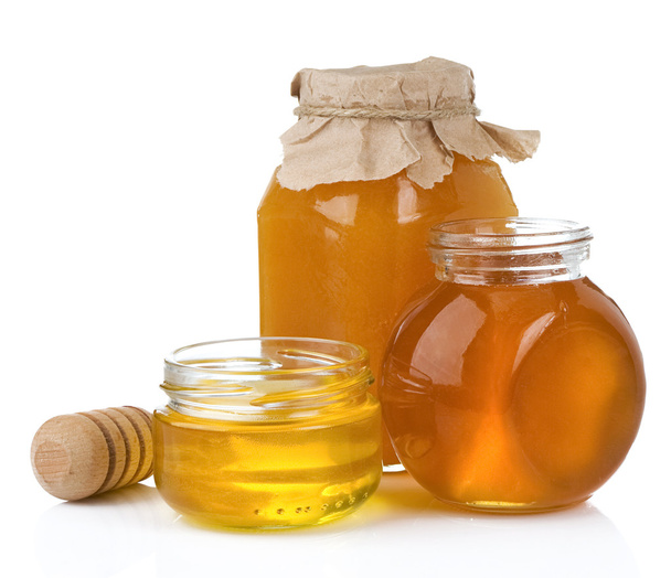 Glass jar and pot of honey with stick - Foto, immagini