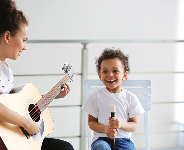 girl and boy playing on music instruments - Foto, Imagen