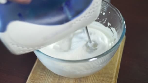Whipping cream in mixing bowl. Making cream. Baking ingredients - Záběry, video