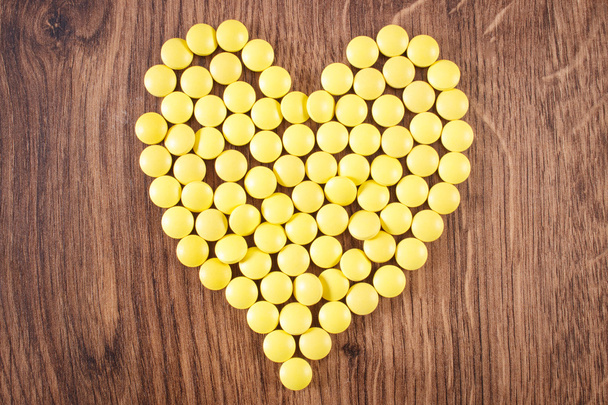 Heart shaped medical pills and capsules, health care concept - 写真・画像
