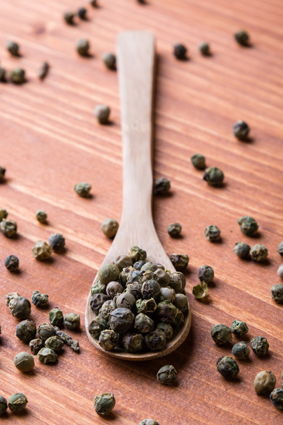 green peppercorn seeds on wooden table  - Photo, Image