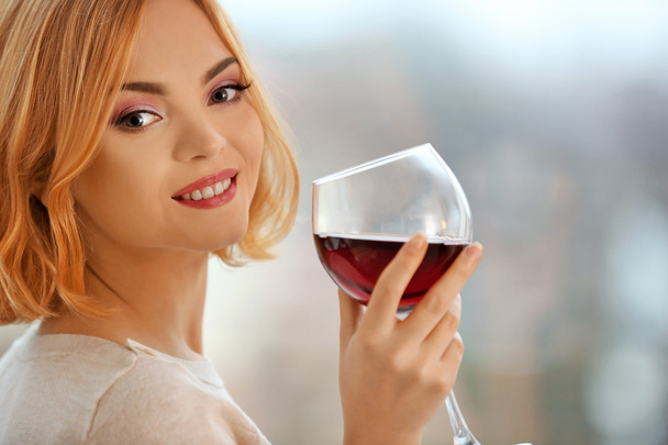 woman with glass of red wine  - Фото, изображение