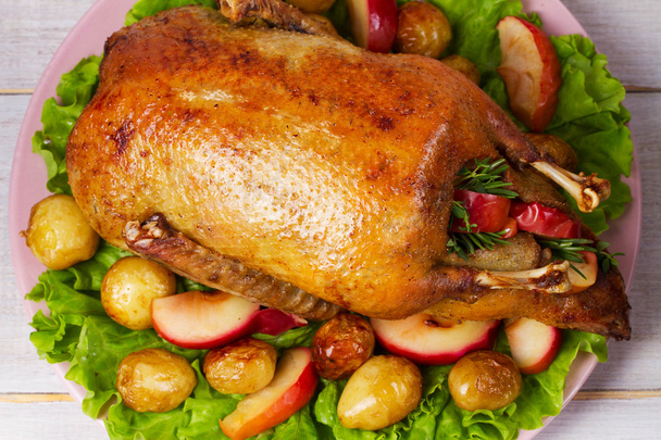 Roast duck with potato, apples, salad, thyme and rosemary - Φωτογραφία, εικόνα