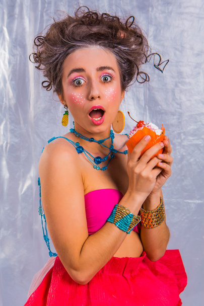 Beautiful  girl with colorful cherry muffin  - Fotoğraf, Görsel