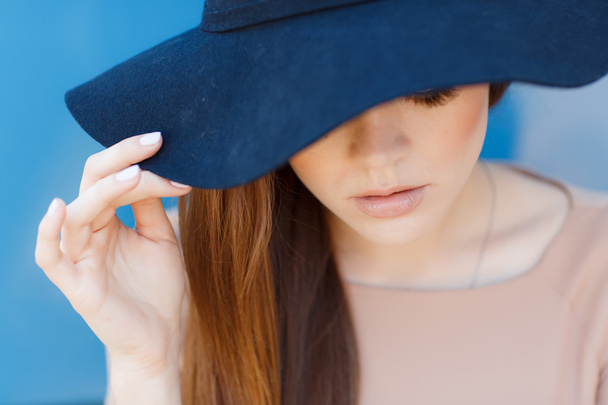 Closeup portrait of a beautiful young woman with hat outdoor looking at camera - Foto, Imagem