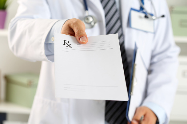 Male medicine doctor hand hold clipboard pad and give prescripti - Photo, Image