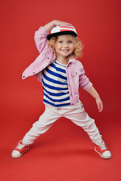 Portrait of a cute little girl in fashionable clothes. beautiful child - Fotó, kép