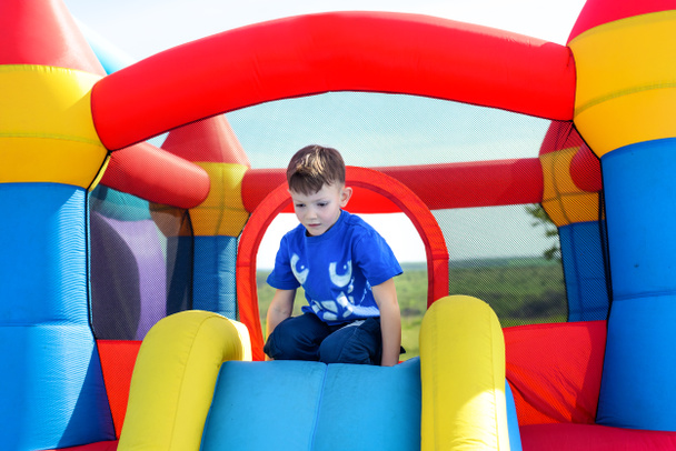 Young boy playing on a bouncy castle - Photo, Image