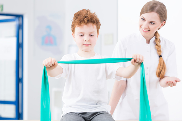 Physical therapist exercising with boy - Photo, Image