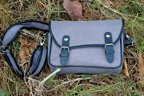 Gray bag on the grass (Selective focus) - Photo, Image