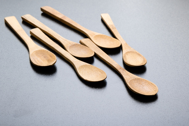 wooden spoons on black table - Foto, Imagen