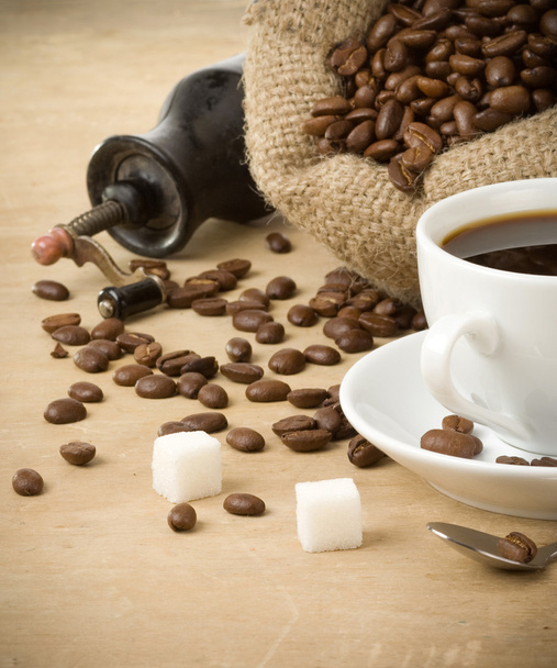 Cup of coffee and grinder on wood - Fotó, kép
