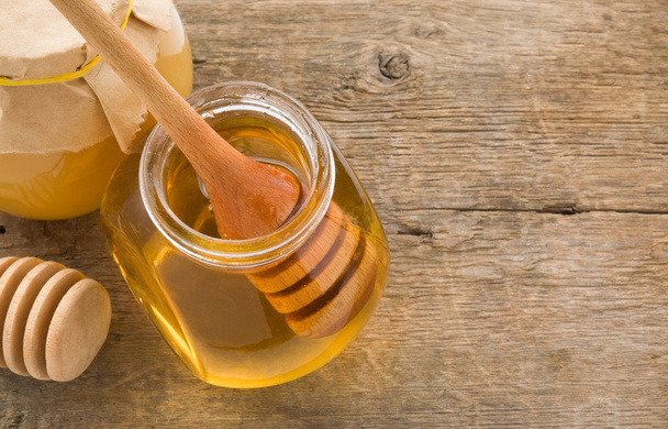 Jar of honey and stick - Foto, Bild