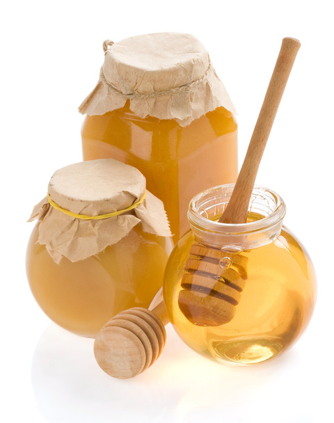 Glass jar full of honey and stick - Foto, Imagem