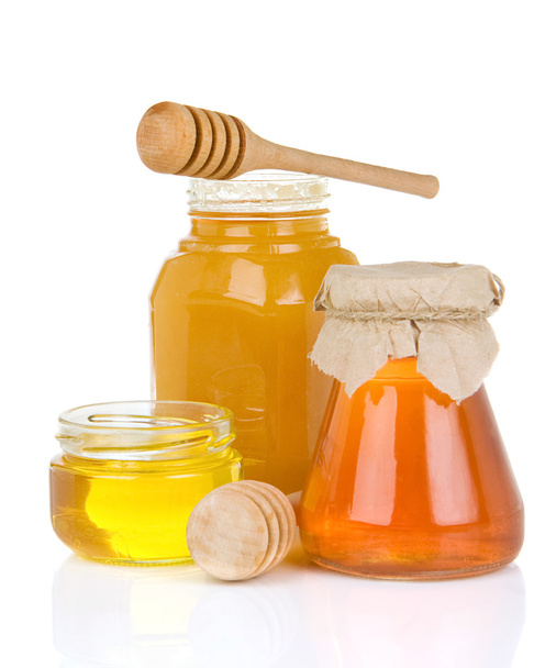 Glass jar full of honey and stick - Foto, immagini