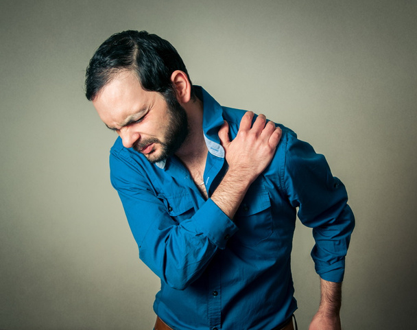 bearded man has a shoulder pain - Фото, изображение