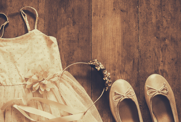 vintage chiffon girl's dress, floral tiara next to ballet shoes - Foto, imagen