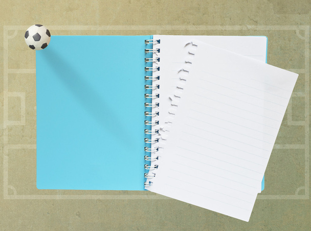 Blank Note Book with plasticine football on paper background (blue) - 写真・画像