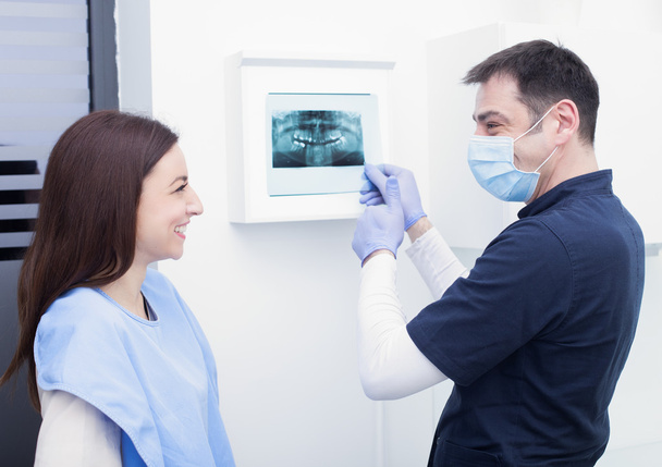 dentist showing x-ray to patient  - Фото, изображение