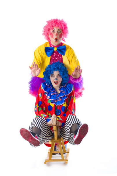 two funny colorful clown fooling around on a white background - Photo, Image