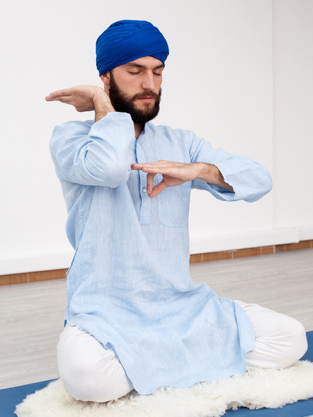  man in a turban sitting on the mat doing mudra - Photo, Image
