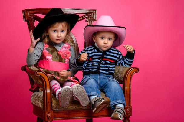 two children smiling wearing cowboy hats - Photo, image