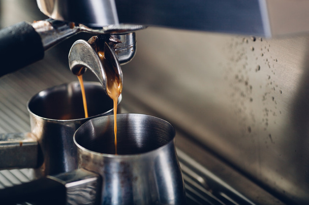 close-up of espresso pouring from coffee machine - Foto, Imagen