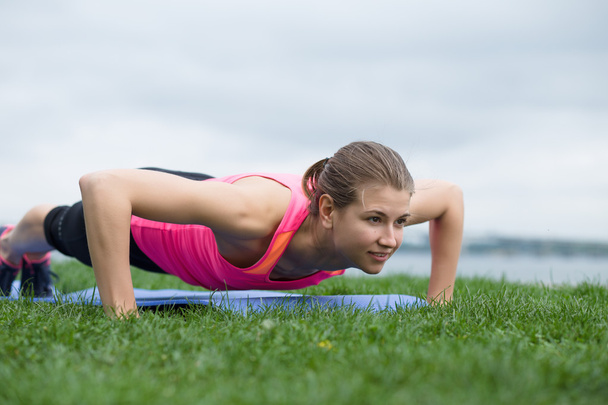 woman doing push up exercises - Photo, image
